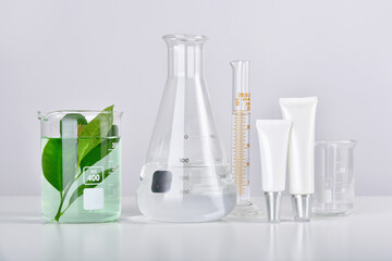 Wall Mural - Natural skincare beauty product research, Organic botany extraction in scientific glassware at science laboratory, Blank cosmetic bottle container for branding mock-up.