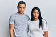 © Krakenimages.com - Young latin couple wearing casual clothes skeptic and nervous, frowning upset because of problem. negative person.