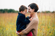 © Sarah Rypma - Portrait of mother holding young happy boy outdoors