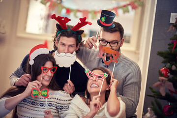 Wall Mural - Group of friends celebrating Christmas at home