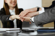 © Iryna - Unknown business people group joining hands in modern office. Businessmen and women making circle with their hands as a team, close-up