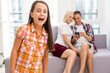 © Angelov - Happy family with child using technologies while sitting on sofa at home