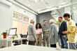 © Svitlana - Cheerful young team greeting new employees, Aged man and woman, senior interns shaking hands with colleagues in the modern office