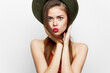 © SHOTPRIME STUDIO - Portrait of a woman in a hat Holds his hands near the face for a kiss red lips