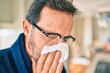 © Krakenimages.com - Middle age man feeling sick with cold and fever at home, ill with flu disease