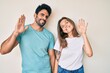 © Krakenimages.com - Beautiful young couple of boyfriend and girlfriend together waiving saying hello happy and smiling, friendly welcome gesture