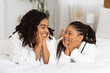 © Prostock-studio - Mother Daughter Love. Black Girl And Mom Lying On Bed In Bathrobes