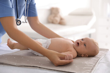 Canvas Print - Doctor examining cute baby in clinic, closeup. Health care