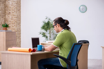 Young male designer working in the office