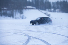 SUV Car Drifting In Snow, During Competition, Sport Car Racing Drift On Snowy Race Track In Winter.