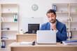 © Elnur - Young male businessman employee working in the office