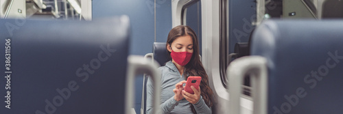 Cuadros en Lienzo Train passenger using mobile phone during travel commute wearing face mask for coronavirus pandemic