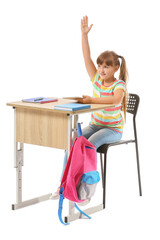 Poster - Little pupil with raised hand sitting at school desk against white background