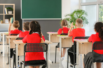 Sticker - Cute pupils during lesson in classroom