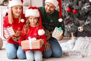 Poster - Young family with Christmas gifts at home