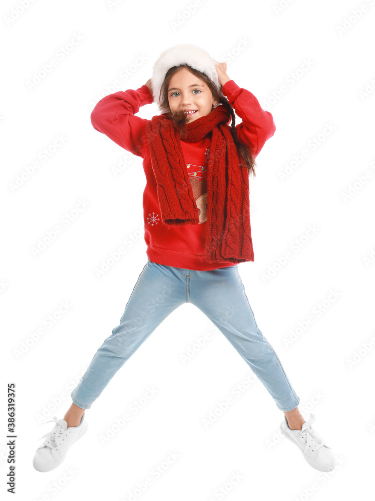 Jumping little girl in Santa Claus hat on white background