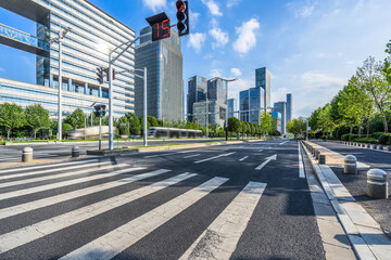 empty road with zebra crossing and skyscrapers in modern city.