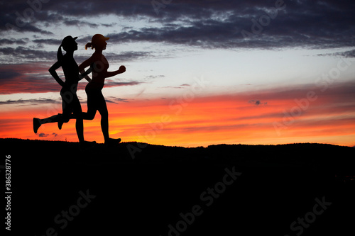 Obraz Dibond Runner during sunset - fitness work out concept