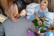 © Odua Images - male sellers pick up green chilies to be weighed serving female buyers at the vegetable stall