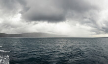 Dramatic Image Of Agitated Sea Near Mountain Island, Croatia.