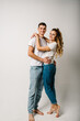 © Serhii - Couple in denim casual style clothes. Fashion models on white background. Smiling young man and woman posing together. Happy family couple.