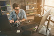 © deagreez - Portrait of his he nice attractive confident focused geek guy tech manager inventing repairing copter air drone home-based at modern brick loft interior style work place station indoors