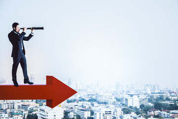 Canvas Print - Businessman standing on red arrow and using binoculars