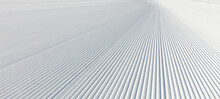 Close-up Straight Line Rows Of Freshly Prepared Groomed Ski Slope Piste.