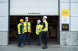 © Halfpoint - Group of workers with face mask talking in front of warehouse, coronavirus concept.