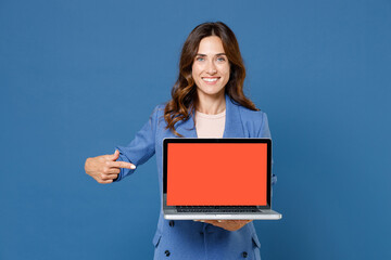 smiling young brunette woman 20s wearing basic jacket pointing index finger on laptop pc computer wi