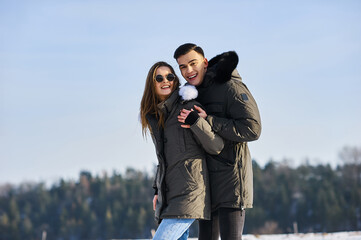 Wall Mural - happy couple hugging and laughing outdoors in winter