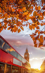 Fototapete - Big Ben against colorful sunset with red bus during autumn in London, England
