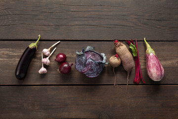 Wall Mural - Purple vegetables on a wooden table. Organic harvest.