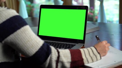 Teen girl school student by webcam conference call remote learning green screen laptop. Internet tutor teaching web class. E learning from home concept. Over shoulder close up laptop screen view.