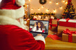 © Studio Romantic - Santa Claus video calling a happy African American girl to wish her Merry Christmas