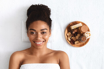 Wall Mural - Smiling black lady having aromatherapy session at spa