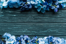 Top View Of Wooden Green Background With Blue Floral Borders