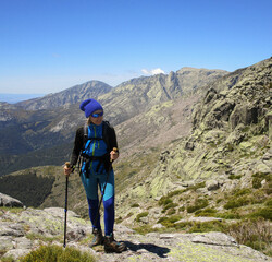 BLOND WOMAN HIKING IN THE MOUNTAIN