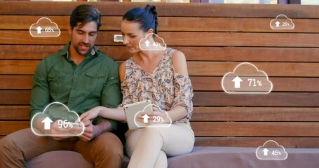 Poster - Multiple cloud icon with increasing percentage against man and woman using smartphone and digital ta