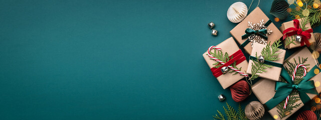 banner with many gift boxes tied velvet ribbons and paper decorations on turquoise background. chris