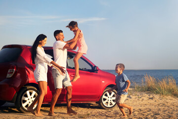 Canvas Print - Happy family having fun near car on sandy beach. Summer trip