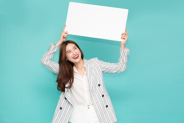 Wall Mural - Young asian woman showing and holding blank white billboard