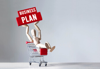 Poster - Wooden man hold a red wooden block with word Business Plan ,concept