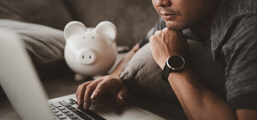 Poster - Smart Asian Man calculate expenses finance with laptop and planning Looking for saving and investment. lifestyle and business concept.