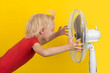 © somemeans - Boy is enjoying the cold air of the fan. Summer heat. Child and fan on yellow background