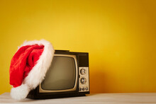 Retro Television With Christmas Hat On Yellow Background
