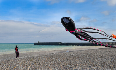 DIEPPE, FRANCE - SEPTEMBER 11, 2018: Kite festival. Octopus kites in the sky in Atlantic ocean