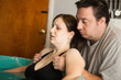 © IdeaBug, Inc. - Man Comforting Wife in Labor in Birthing Pool During at Home Birth