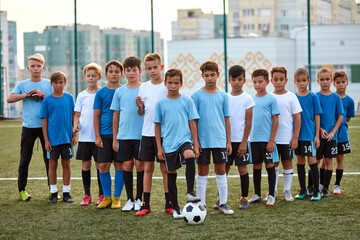 young football players boys ready to play, they divided into groups, going to participate in the competition