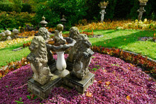 Faded Fall Garden With Lion And Cherub Statues In Sunshine